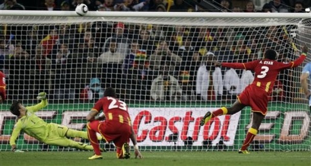 Ghana's Asamoah Gyan, right, misses on a penalty shot as Uruguay goalkeeper Fernando Muslera, bottom left, looks up during the World Cup quarterfinal soccer match between Uruguay and Ghana at Soccer City in Johannesburg, South Africa, Friday, July 2, 2010. (AP Photo/Luca Bruno)