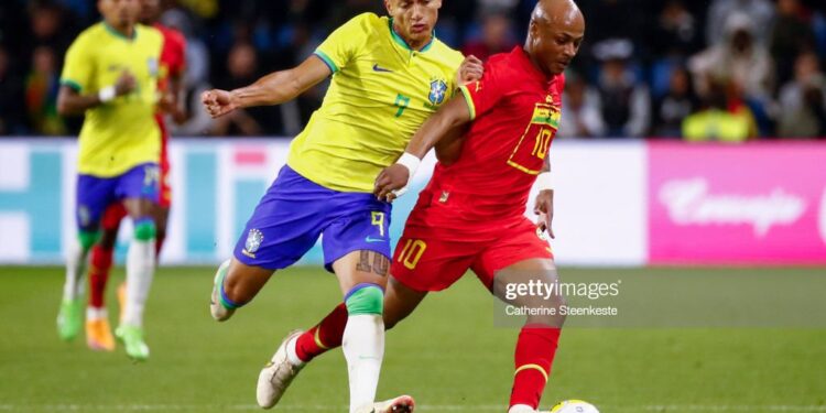 LE HAVRE, FRANCE - SEPTEMBER 23: Richarlison #9 of Brazil challenges Andre Ayew #10 of Ghana during the international friendly match between Brazil and Ghana at Stade Oceane on September 23, 2022 in Le Havre, France. (Photo by Catherine Steenkeste/Getty Images)