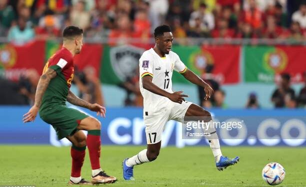 DOHA, QATAR - NOVEMBER 24: Baba Rahman of Ghana and Joao Cancelo of Portugal during the FIFA World Cup Qatar 2022 Group H match between Portugal and Ghana at Stadium 974 on November 24, 2022 in Doha, Qatar. (Photo by Youssef Loulidi/Fantasista/Getty Images)