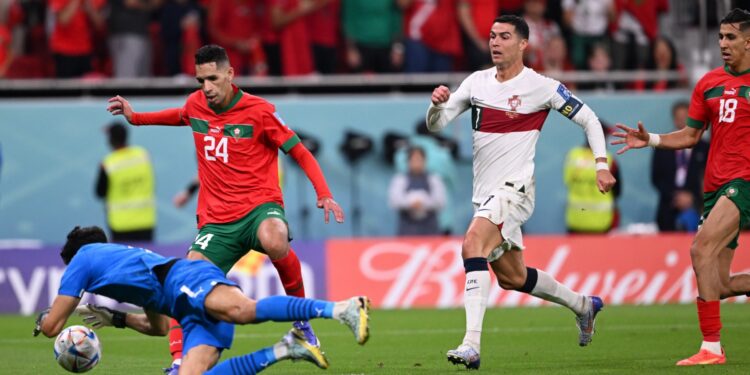 Morocco's goalkeeper #01 Yassine Bounou saves a shot by Portugal's forward #07 Cristiano Ronaldo during the Qatar 2022 World Cup quarter-final football match between Morocco and Portugal at the Al-Thumama Stadium in Doha on December 10, 2022. (Photo by Kirill KUDRYAVTSEV / AFP)