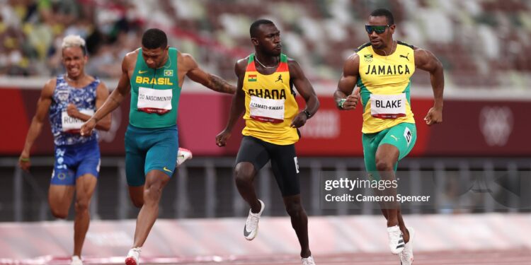 TOKYO, JAPAN - JULY 31: Benjamin Azamati-Kwaku (2R) of Team Ghana reacts towards Yohan Blake of Team Jamaica during their Men's 100m Round 1 heats on day eight of the Tokyo 2020 Olympic Games at Olympic Stadium on July 31, 2021 in Tokyo, Japan. (Photo by Cameron Spencer/Getty Images)