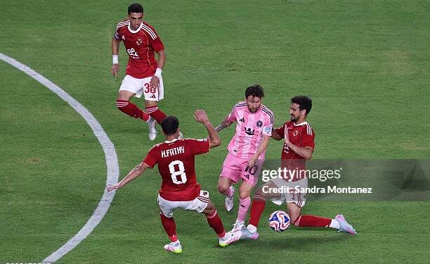 MIAMI GARDENS, FLORIDA - JUNE 14: Lionel Messi #10 of Inter Miami CF is challenged by Hamdy Fathy #8 and Mohamed Ali Ben Romdhane #5 of Al Ahly FC during the FIFA Club World Cup 2025 group A match between Al Ahly FC and Internacional CF Miami at Hard Rock Stadium on June 14, 2025 in Miami Gardens, Florida. (Photo by Sandra Montanez/Getty Images)