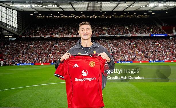 MANCHESTER, ENGLAND - AUGUST 9: New Manchester United signing Benjamin Sesko poses with a team shirt prior to the pre-season friendly match between Manchester United and ACF Fiorentina at Old Trafford on August 9, 2025 in Manchester, England. (Photo by Ash Donelon/Manchester United via Getty Images)