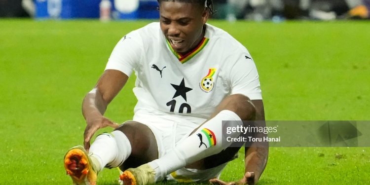 TOYOTA, JAPAN - NOVEMBER 14: Francis Abu of Ghana reacts after breaking his leg during the international friendly match between Japan and Ghana at Toyota Stadium on November 14, 2025 in Toyota, Aichi, Japan. (Photo by Toru Hanai/Getty Images)